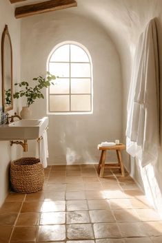 a bath room with a toilet a sink and a window