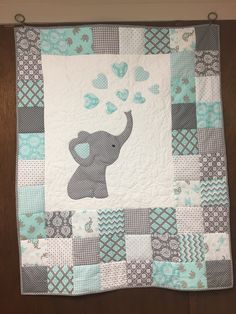 a baby quilt with an elephant on it