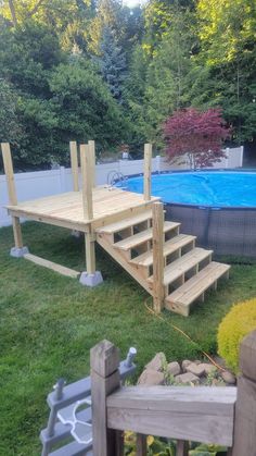 a wooden deck next to a swimming pool