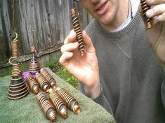 a man is holding up some metal objects