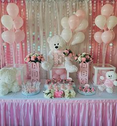 a teddy bear themed birthday party with pink and white balloons, flowers, and decorations