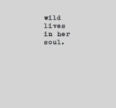 the words wild lives in her soul are written on a gray background with black ink