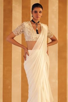 Ivory pre-draped solid saree crafted in chiffon. Paired with a half sleeves deep U neck blouse with all over misty pearl bloom embroidery. - Aza Fashions Elegant White Georgette Blouse, Silk Wedding Blouse With Draped Sleeves, Wedding Blouse With Draped Sleeves And Fitted Style, Elegant White Blouse With Sheer Dupatta, Fitted Blouse With Draped Sleeves For Wedding, Fitted Wedding Blouse With Draped Sleeves, White Georgette Blouse For Reception, White Blouse With Traditional Drape For Parties, Elegant White Pre-draped Saree With Traditional Drape