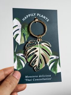 a person holding up a card with a monster plant on it's front and back