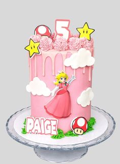 a pink birthday cake with mario and princess peaches on the top, surrounded by stars