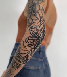 a woman with a tattoo on her arm