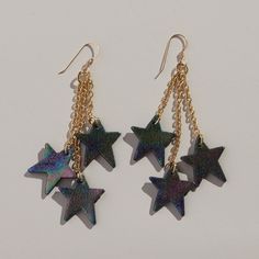 Introducing the Cosmos Juno earrings – a pair of whimsical star earrings that are destined to be the shining highlight of your ensemble. Crafted from custom foiled leather and your choice of silver or gold hardware, these earrings boast a beautiful multi-colored celestial feel with their hand-stamped iridescent shine. Have a night under the starts in this eye-catching accessory. This item is final sale. Silver Necklace Designs, Nickel And Suede, Star Wars Day, The Cosmos, The Shining, Earrings Collection, Juno, Star Earrings, Leather Earrings