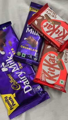 three different types of chocolate bars on a white sheet with the words dairy milk written in it