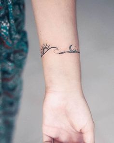 a woman's hand with a small tattoo on the left side of her wrist