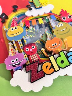 an image of a birthday card with cartoon characters on the front and back side, surrounded by letters that spell out happy