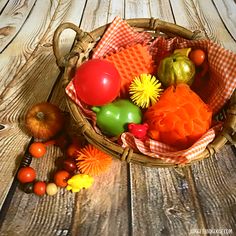 a basket filled with lots of different types of fruit on top of a wooden table