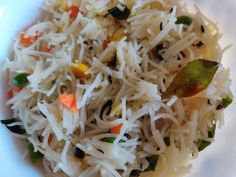 a white plate topped with rice and veggies