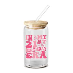 a glass jar with a straw in it and the words in my 21st birthday era