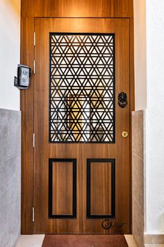 a wooden door with decorative screen on the front and side panels in an entry way