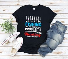 fishing solves the rest t - shirt on a wooden table with jeans and shoes