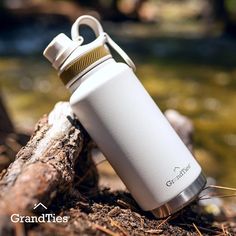 a white water bottle sitting on top of a log