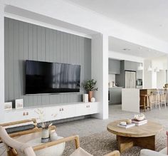 a living room filled with furniture and a flat screen tv