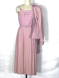 One-of-a-kind 1940s summer weight pale pink suit with a sundress and matching belt. The sundress has a straight neckline and shoulder straps, fitted bodice with six decorative buttons, and pleated skirt with hidden zipper. Has a fitted jacket with a wing collar, shoulder pads, pockets on the hips, cuffed sleeves, and three matching buttons.  Condition: excellent vintage condition Label: The Higbee Co. Cleveland Circa: 1940s Composition: most likely linen Size: small  Jacket Measurements: Shoulde 1940s Summer, Suit With Belt, 1940s Suit, Fashion Decades, Small Jacket, Music Inspiration, Wing Collar, Summer Suit, Womens Suits