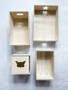 three wooden boxes with different shapes and sizes on the top one has a butterfly cut out