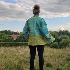 Beautiful handmade, colourful quilt short jacket with pockets, bohemian style and kimono cut, oversized. It's handmade 100% cotton quilt coat, reversible - one side is multicolor /in blue, yellow and green color/ patchwork fabric and second side is solid /lime color/ fabric. Inside cotton batting. Pockets on patchwork side. Size : S/M EU WOMAN'S  /for better wearing comfort, the coat must be little oversize/. Length : 28 1/2 inches (72 cm)  Bust/Chest : 47 1/2 inches (120 cm) Sleeve : customize All my works are myself handmade and unique. The coat is easy care and can be machine washed separately on a gentle cycle in cool water. FREE SHIPPING WORLDWIDE ! Patchwork Kimono Sleeve Outerwear For Festival, Festival Outerwear With Patchwork And Kimono Sleeves, Traditional Oversized Outerwear For Spring, Quilted Bohemian Long Sleeve Outerwear, Oversized Cotton Quilted Jacket, Cotton Relaxed Fit Festival Outerwear, Festival Cotton Outerwear With Kimono Sleeves, Bohemian Quilted Spring Outerwear, Oversized Bohemian Cotton Outerwear