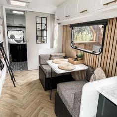 the interior of an rv is clean and ready to be used as a dining area