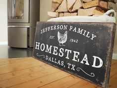 a sign sitting on top of a wooden table next to a pile of wood logs