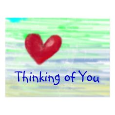 a red heart with the words thinking of you in blue ink on a green background