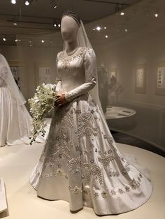 a wedding dress on display in a museum