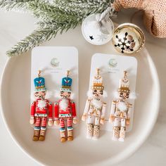 three wooden nutcrackers are sitting next to each other on a white plate