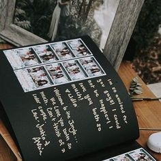 a table topped with pictures and writing on top of a wooden table next to a computer mouse