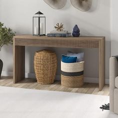 a living room with a couch, table and two baskets on the floor in front of it