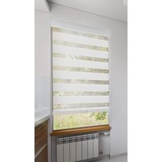 a white window with blinds on it in a bathroom next to a radiator