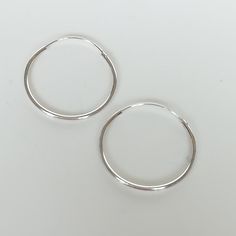 Sterling silver ear hoops. Dimensions: 25 X 1.2mm Price listed is for a PAIR of hoops. These earrings are made of 925 hypoallergenic sterling silver. Most of my pieces come with a 925 stamp. Can be packaged in a gift box. I can include a personal message from you if needed You are welcome to contact me at... bhavnakwintra1956@gmail.com For more beautiful pieces from my shop, please browse 👇 TOE RINGS: https://www.etsy.com/your/shops/TheSilverGame/tools/listings/section:27020628,view:table EAR H Nickel-free Sterling Silver Hoop Earrings For Everyday, Simple Sterling Silver Hoop Earrings For Everyday, Handmade Minimalist Huggie Hoop Earrings, Minimalist Handmade Huggie Hoop Earrings, Simple Adjustable Sterling Silver Hoop Earrings, Hypoallergenic Sterling Silver Hoop Earrings, Sterling Silver Hypoallergenic Hoop Earrings For Everyday, Silver Small Hoop Earrings For Everyday, Silver Dainty Hoop Earrings For Everyday