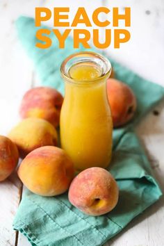 peach syrup in a glass jar next to fresh peaches on a green napkin with text overlay