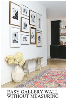 a room with pictures on the wall and a bench in front of it next to a rug