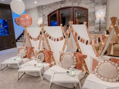 a living room filled with lots of furniture and balloons