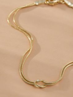 This stunning piece features two delicate chains, gracefully intertwined, creating a sophisticated and timeless look. Perfect for any occasion, this bracelet effortlessly adds a touch of refinement to your wrist. Pair it with the matching 18K Gold Layered Knot Necklace for a matching look. Romper And Boots, White Dress Boots, Skirts With Boots, Knot Bracelet, Gold Dipped, Knot Necklace, Altar'd State, Dress With Boots, Jewelry Box