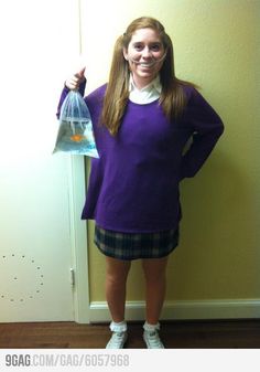 a woman in purple shirt and plaid skirt holding up a plastic bag