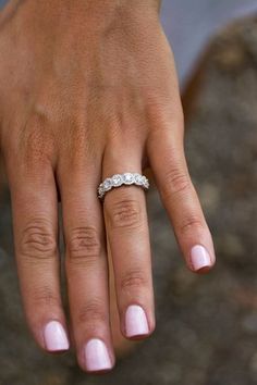 a woman's hand with a wedding ring on it