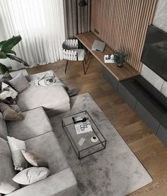 an aerial view of a living room with couches, coffee table and television