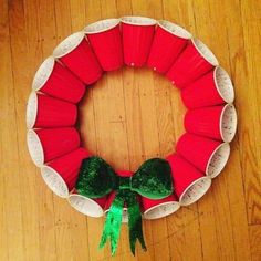 a paper plate wreath with green bows on it