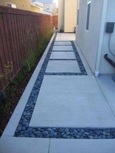 an image of a walkway made out of stones and gravel with grass in the background