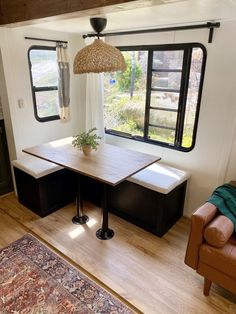 a living area with a couch, table and window