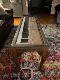 a piano sitting on top of a rug in a living room