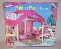 a pink barbie doll house with furniture and accessories in the box on top of it