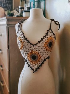 a crocheted top with sunflowers on it