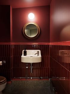 a bathroom with a sink, mirror and toilet