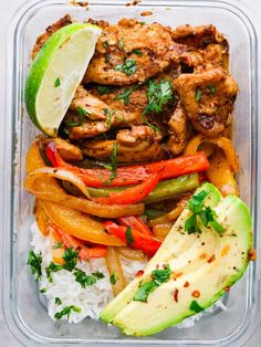 a plastic container filled with rice, meat and veggies next to an avocado