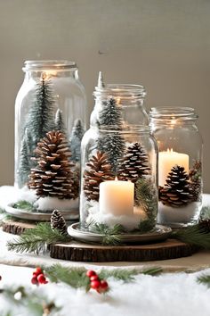 three mason jars filled with pine cones and lit candles