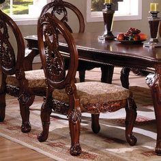 a dining room table and chairs with candles on the end tables in front of them